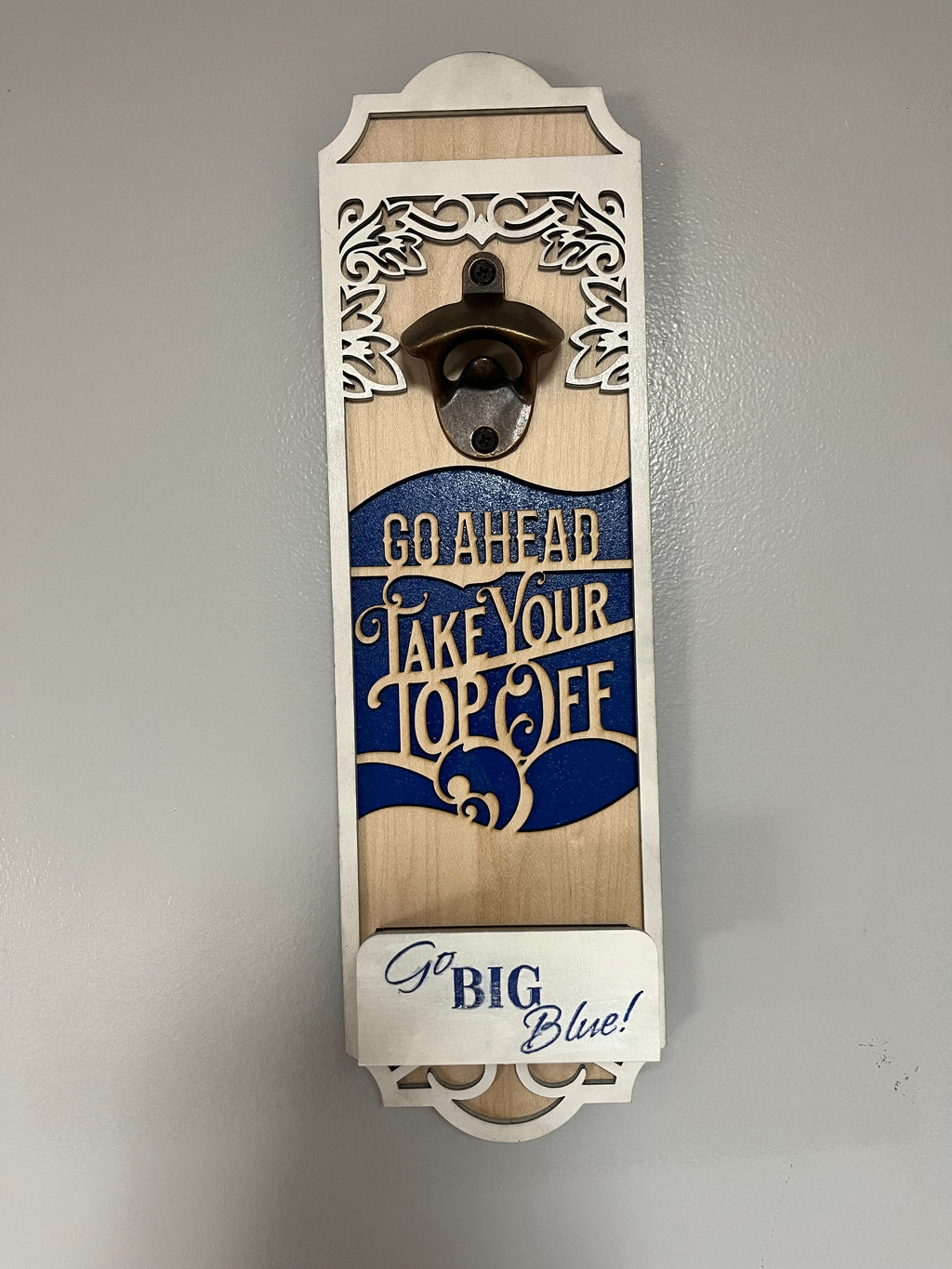 Sherrie’s Ky Creations bottle opener with a sleek metal design, perfect for opening bottles easily and stylishly.