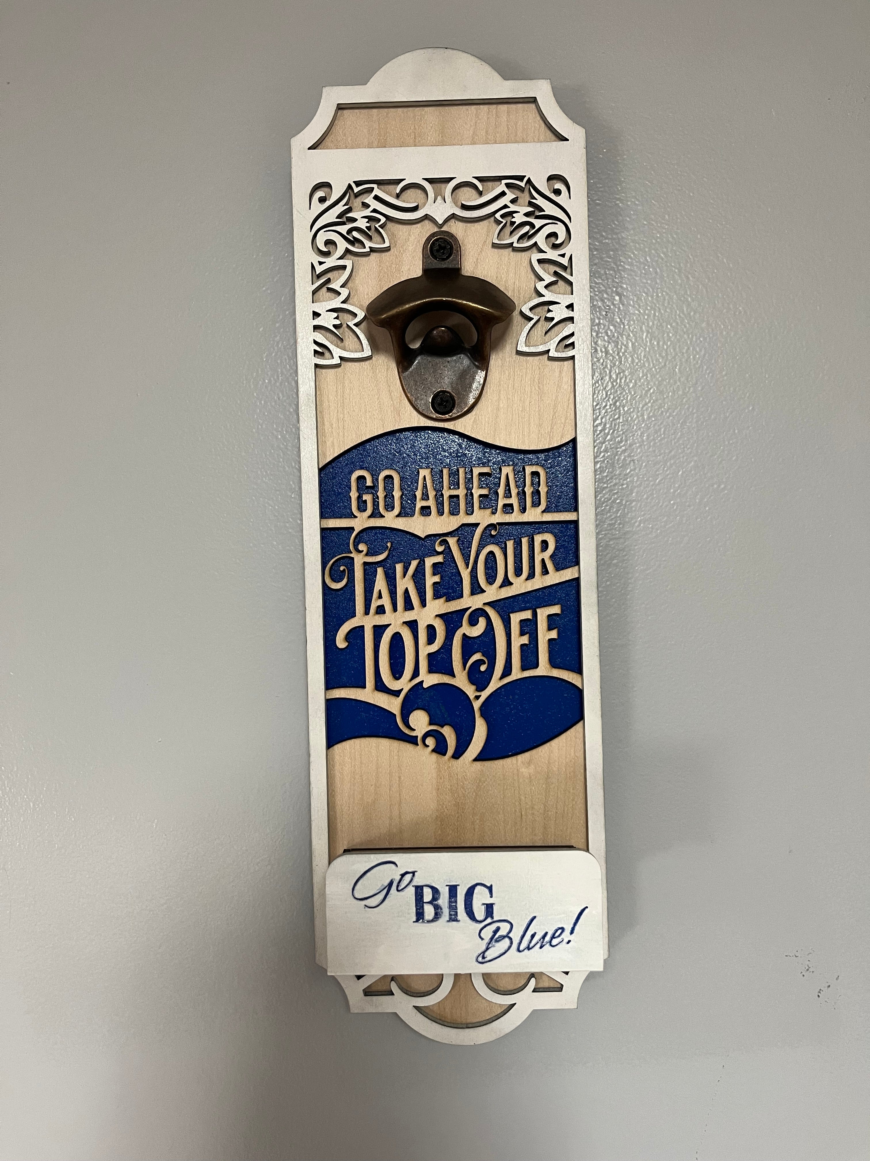 Sherrie’s Ky Creations bottle opener with a sleek metal design, perfect for opening bottles easily and stylishly.