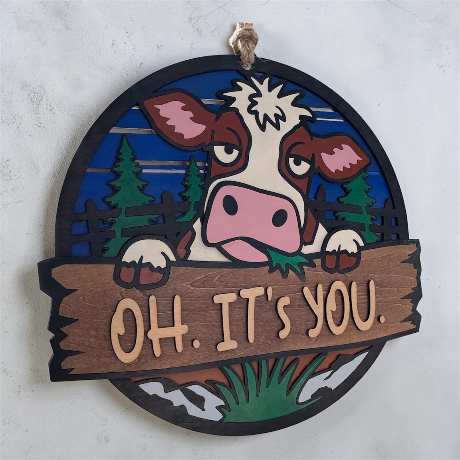 Cow door hanger with "Oh. It’s you." phrase, decorative wooden sign by Sherrie’s Ky Creations hanging on a door.