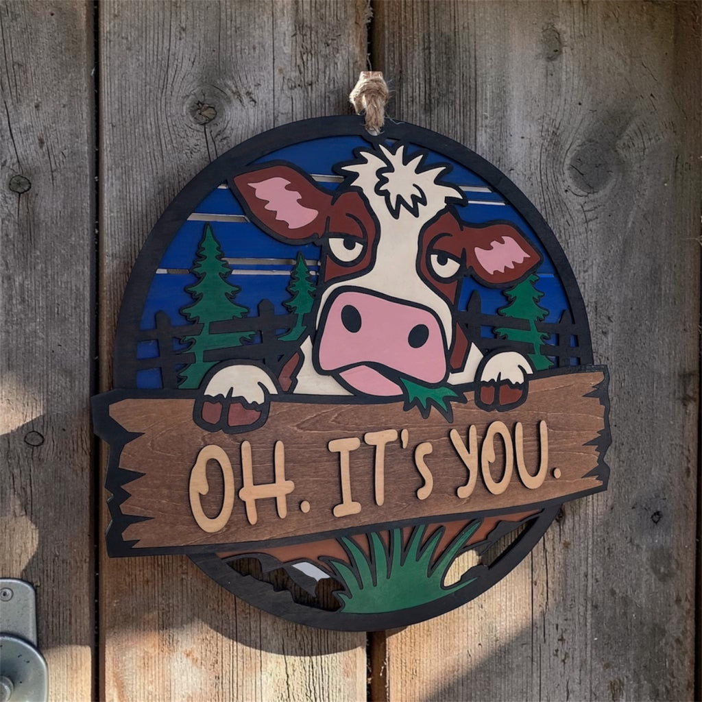 Cow-shaped door hanger with "Oh. It’s you." message by Sherrie’s Ky Creations, featuring a charming, rustic design.